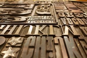 The psychology of fonts illustrated with a board of fonts in wood.