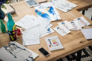 Fashion design labels all over a table. 