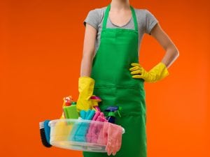 a green apron and yellow cleaning gloves. Starting your own maid service requires good reputation