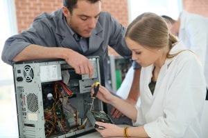 An it tech fixing a computer