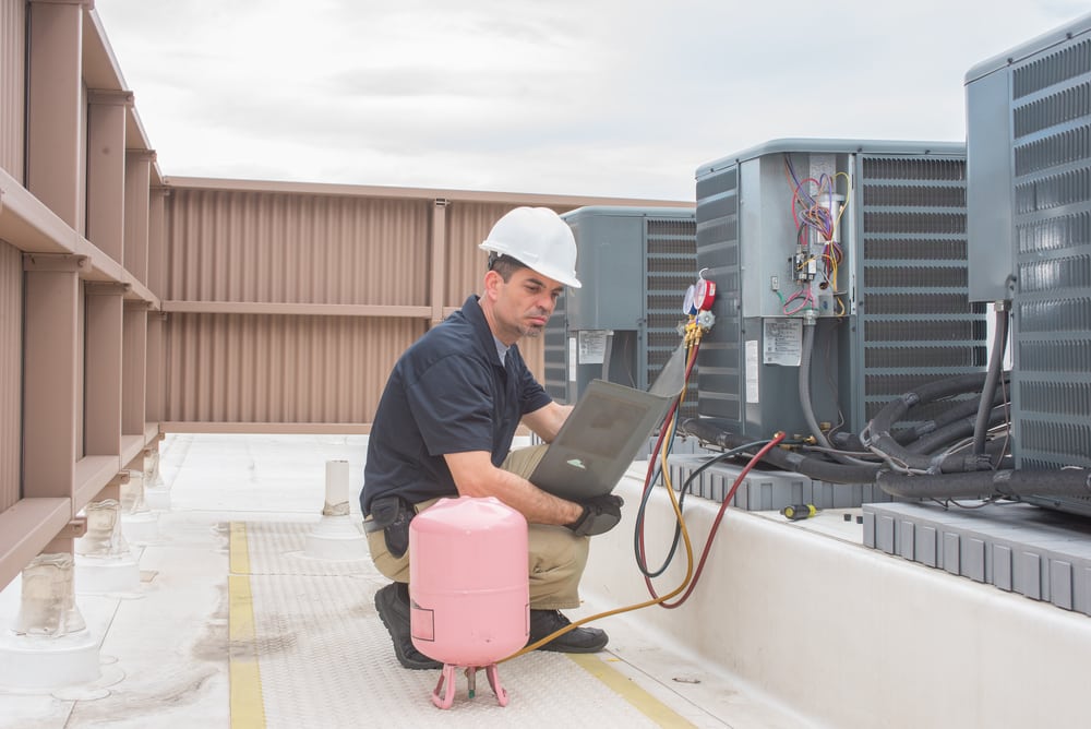 A man sitting down looking at a plan to market a HVAC