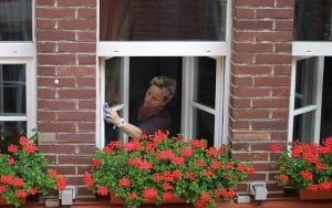 A woman cleaning windows. on the outside. A professional logo is the only way to show potential customers what your cleaning business can do. 