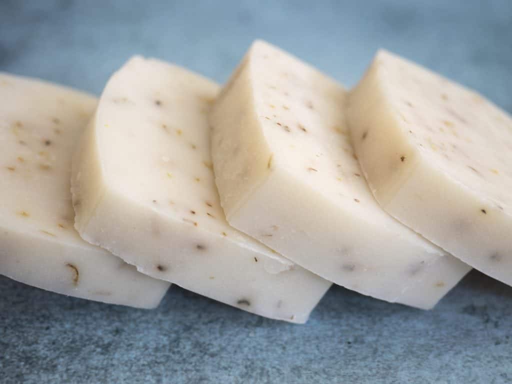 4 bars of all-natural soap lined up on a counter.