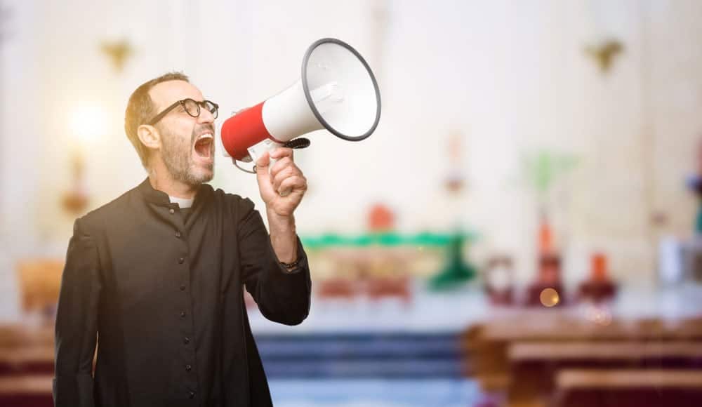 A man shouting something in a megaphone. The backgrounds is a church. Your logo matters to differentiate yourself from other churches