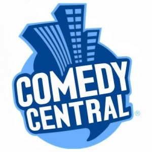 Comedy Central's old logo with the letter C. Blue tall buildings in the background with a white fat font