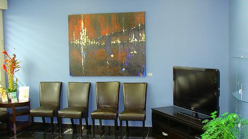 A waiting room at the doctors. Four old fashioned chairs. 