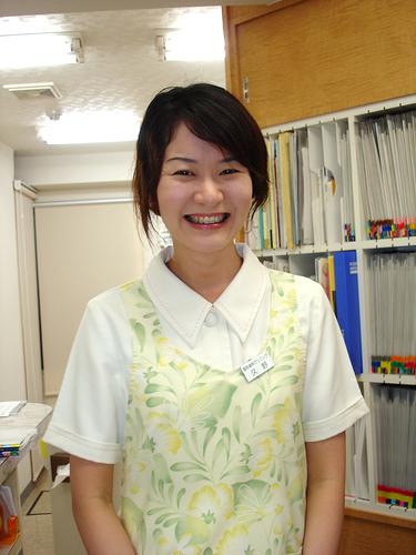 A smiling employee doing her part in representing the company and reinforcing brand identity