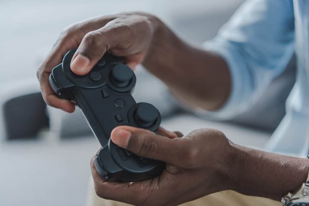 An adult man playing the Nintendo. Video game stores can be full of old and new games