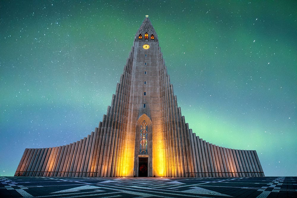 The magnificent church in Reykjavik Iceland. The sky is filled with northern lights. Marketing your church can involve the use of powerful images. 