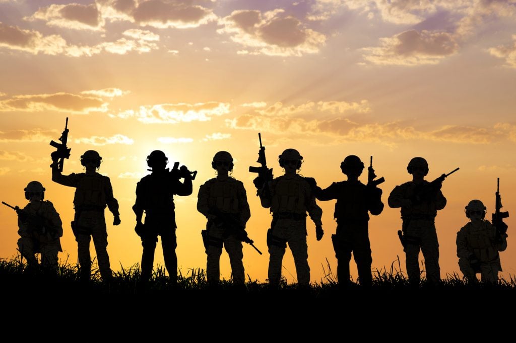 Soldiers standing in line and the sun is setting in the background. Marketing your military group takes time