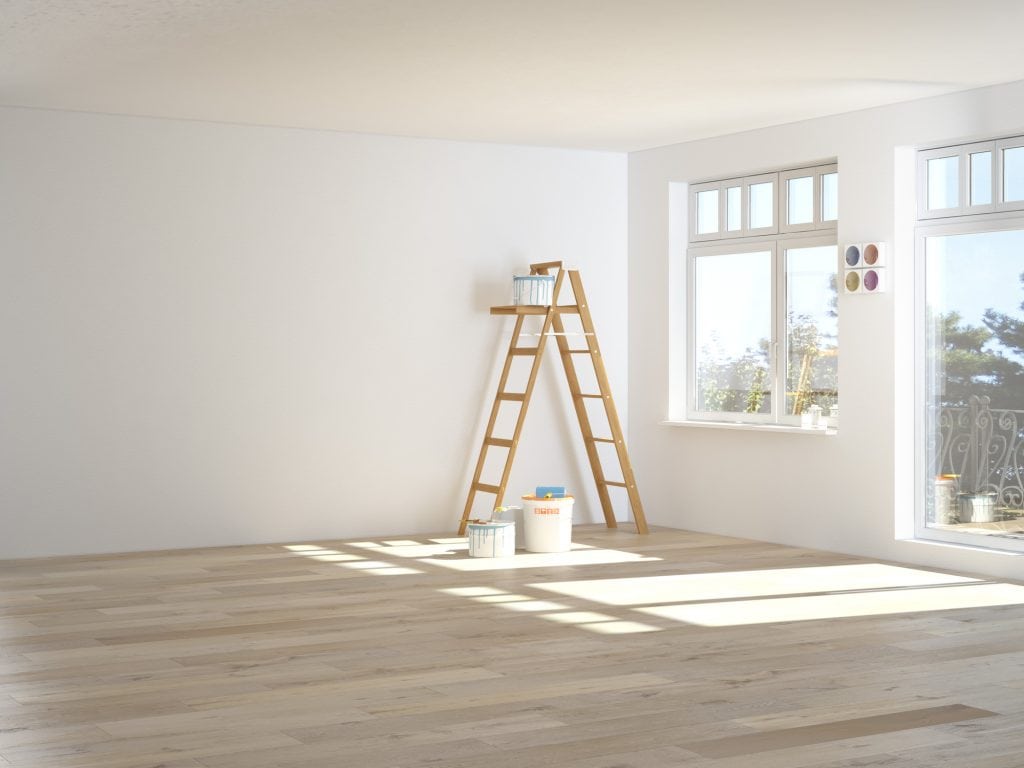 A ladder with paining tins standing in a newly decorated room. A white and light room. Logo designers are a bit like painters but online