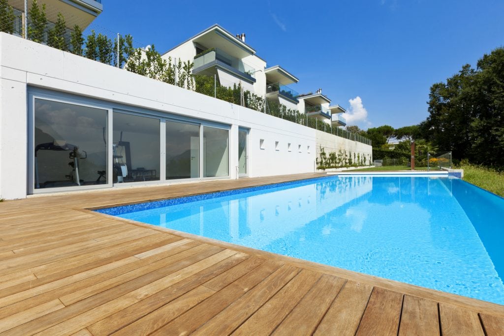 Luxury house with a big pool. Marketing banner for a pool and spa installation business 