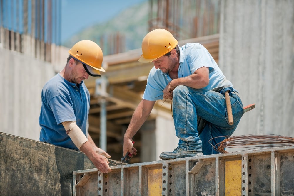 Two working men on a building site.