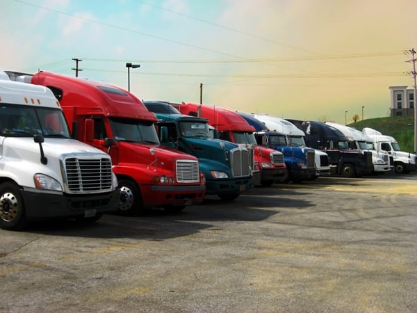 Row of trucks in different colors to show a trucking business. 