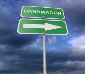Decision making process can be influenced by Bandwagon effect. This is a green sign with the word Bandwagon
