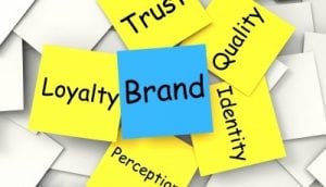 Branding your logo picture where little stickers in yellow and blue describe all the things you should think of such as brand, loyalty, quality, trust, identity and perception. 