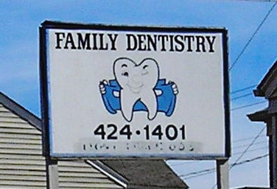 Showing off your sign but not in a good way. Actually this dental look n a pretty bad one. 