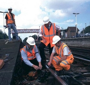 Orange clothing on working men. It is a visible color to sue on building project. I can see why orange would be used in logo design.