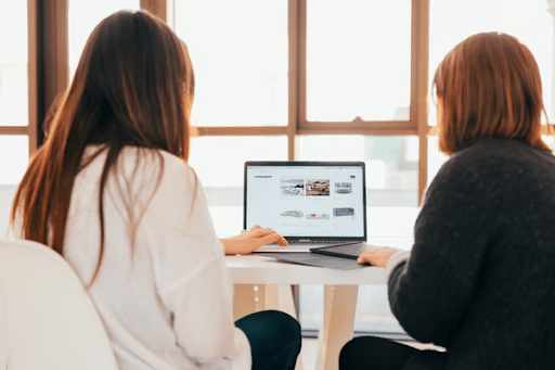 Two women looking at a screen with a great web design