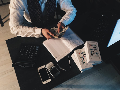 Accountant looking at numbers on a piece of paper. Looking at a possible Accounting Logo Design for his firm.