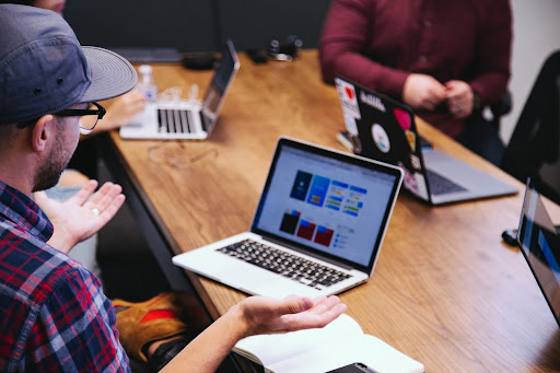 A human being looking at a screen discussion professional logo d and ai logo design