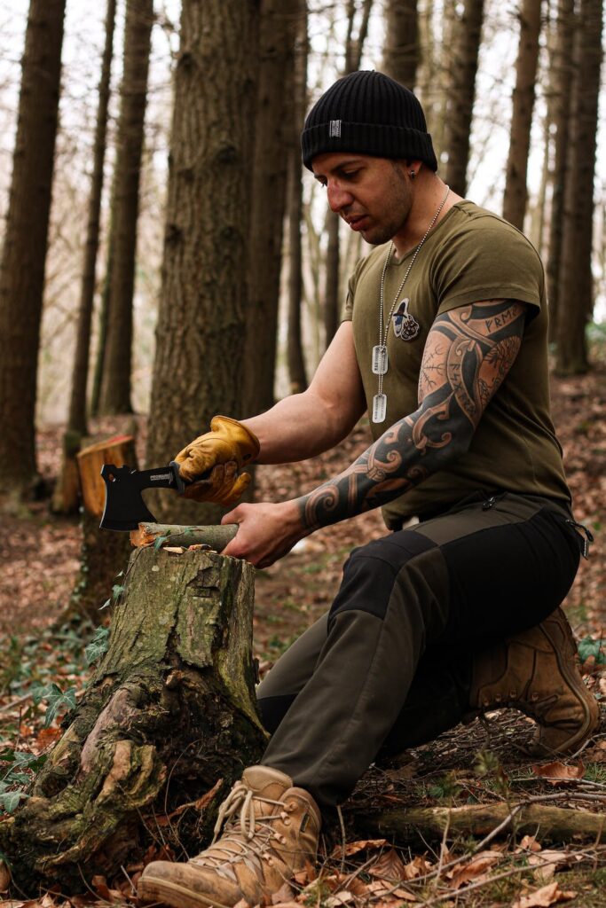 Tattooed man cutting wood. Marketing for tattoo shops needs attractive people to showcase what they can do.