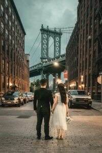 Newly weds looking onto the skyline of New York. Wedding planning business can include honeymoon planning
