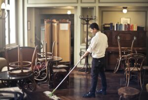 A man cleaning floors in a restaurant. Logo for cleaning business need to be clean and memorable.