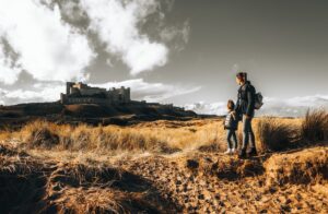 A woman and a child looking at a old medieval castle ruin. Travel websites have professional photos