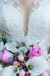 Beautiful wedding dress and flowers fro the bride. A wedding planning business needs to keep all the details in check. 