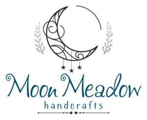 Moon Meadow handcrafts romantic soft logo. A cute moon with three dangling stars.