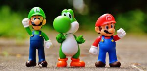 Mario, Luigi, Yoschi figures standing next to each other