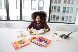 A woman looking into a book researching something