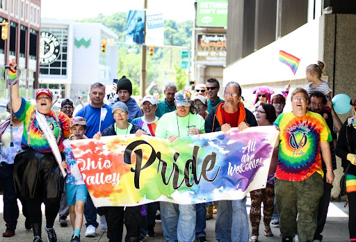 Pride parade. A banner saying pride.