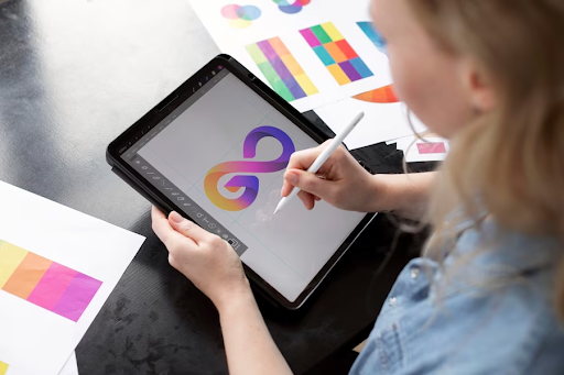 A woman drawing a simple logo on an ipad