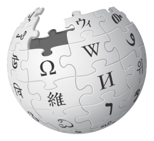 Wikipedia's famous grey logo in she shape of a globe made up of puzzle. 