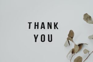 Thank you sign with some leaves. Simple typography tracking
