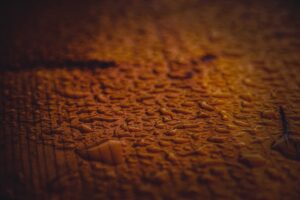 Background of wet wooden surface with drops forming blobs