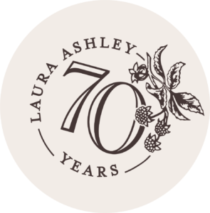 Anniversary logo for Laura Ashley. A decorative flower on the right hand side of a circular logo with the number 70 in the middle. Interior design logo ideas