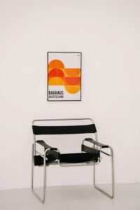 Metal Chair Standing in Front of a White Wall. Graphic design vs logo design