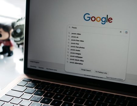 Photo of a Laptop Screen with Google logo font Main Page on It