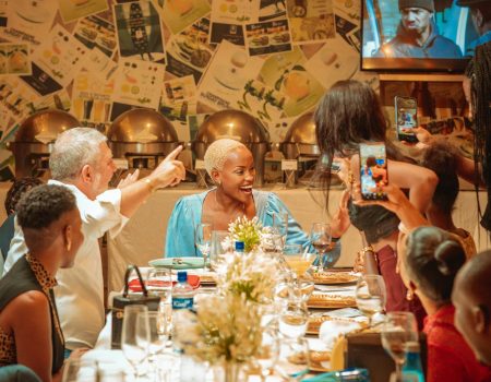 Smiling Family Sitting by Table. Celebrate Friendsgiving with a card