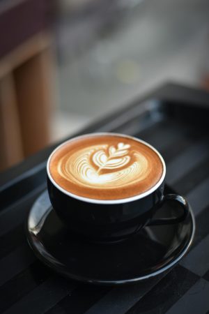 Close-up of Coffee Cup on Table. The cup does not have a café logo design.