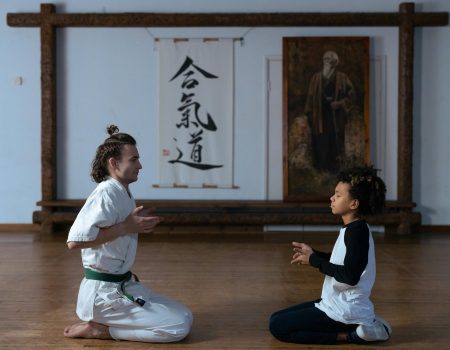 A Man and a Boy Kneeling on the Wooden Floor A Man and a Boy Kneeling on the Wooden Floor. Marketing your martial art school is vital to success.