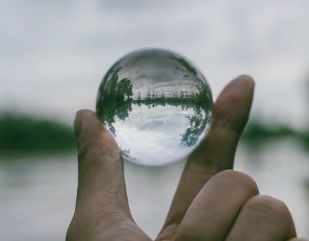 Close-Up Photography of Person Holding Crystal Ball. Transparent logos can be useful on all sorts of products