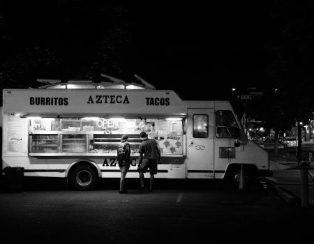 Food truck business open a night selling tacos and burritos. The food truck logo is easily visible.