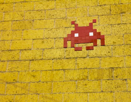 Mosaic Alien on Wall. Pixel art is the beginning of the evolution of different types of digital art