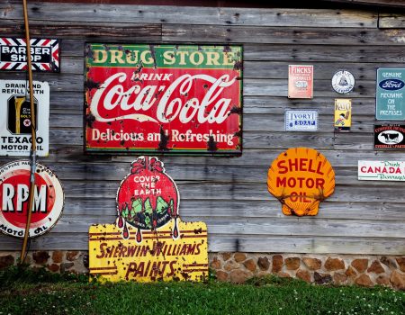 Many types of signages. Indoor and outdoors. A wall full of famous logos and signs