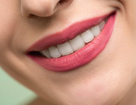 A gorgeous smile with red lips. Logos for dental practices can include symbols like mouths