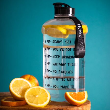 A promotional water bottle surrounded by oranges